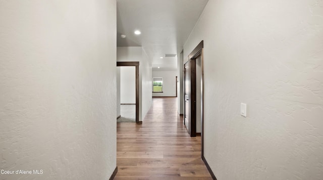 3306 Goodman Dr, Sandpoint, ID 83864 - hallway featuring wood finished floors, a textured wall, and recessed lighting