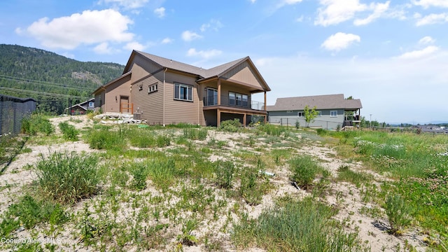 3306 Goodman Dr, Sandpoint, ID 83864 - rear view of house featuring a balcony and a mountain view