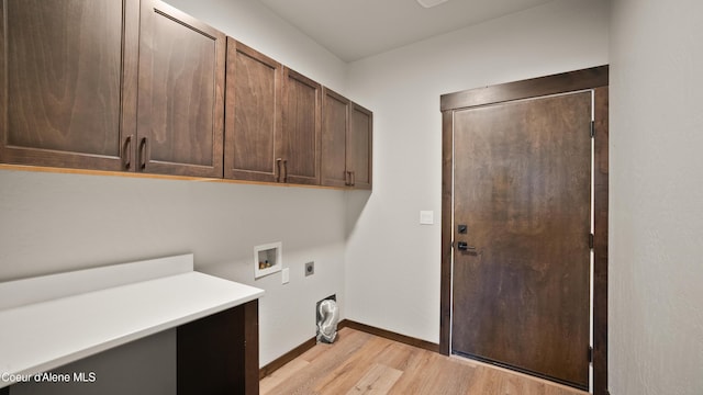 3306 Goodman Dr, Sandpoint, ID 83864 - laundry room featuring cabinet space, electric dryer hookup, light wood finished floors, and hookup for a washing machine
