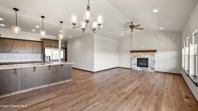 3306 Goodman Dr, Sandpoint, ID 83864 - kitchen featuring stainless steel fridge with ice dispenser, a ceiling fan, a breakfast bar, lofted ceiling, and decorative backsplash