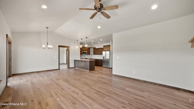 3306 Goodman Dr, Sandpoint, ID 83864 - unfurnished living room featuring a chandelier, ceiling fan, vaulted ceiling, light wood-style flooring, and recessed lighting