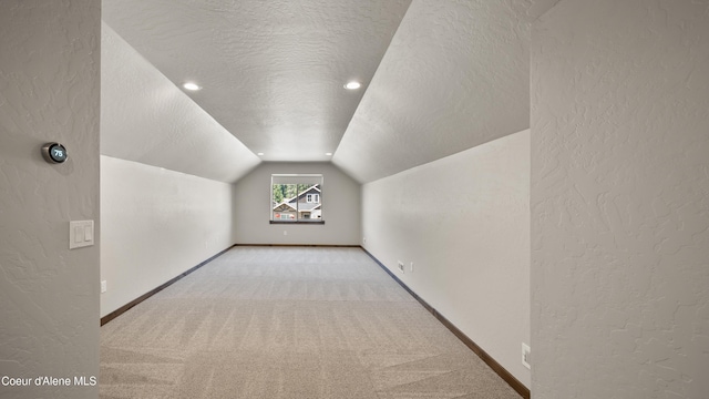 3306 Goodman Dr, Sandpoint, ID 83864 - bonus room featuring a textured ceiling, lofted ceiling, a textured wall, and carpet floors