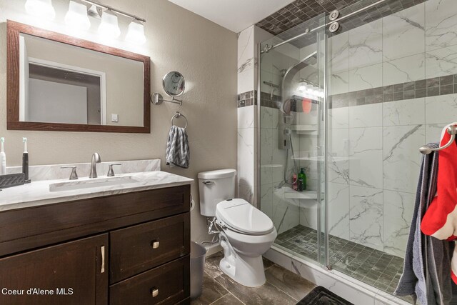 5421 W Fairway Ln # 23, Rathdrum, ID 83858 - full bath with vanity, a shower stall, and a textured wall