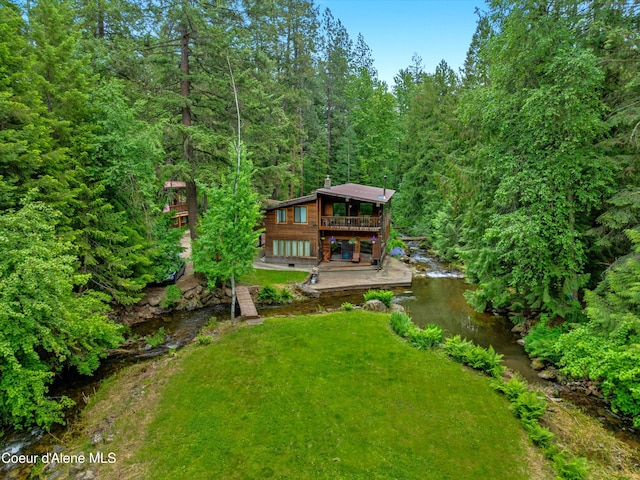 19565 N Goelzer Way, Rathdrum, ID 83858 - view of grassy yard with a deck and a forest view