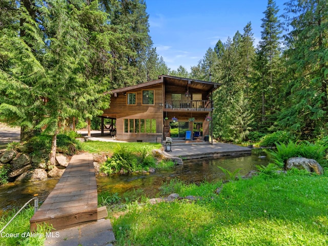 19565 N Goelzer Way, Rathdrum, ID 83858 - rear view of house featuring a patio, stairway, and a water view