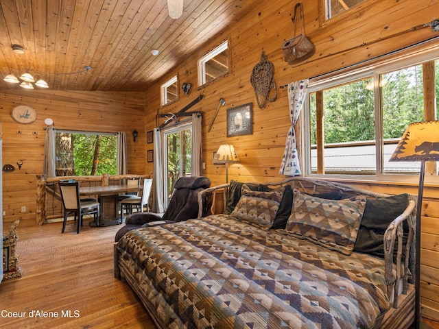 19565 N Goelzer Way, Rathdrum, ID 83858 - bedroom with wood ceiling, wooden walls, access to exterior, and hardwood / wood-style flooring