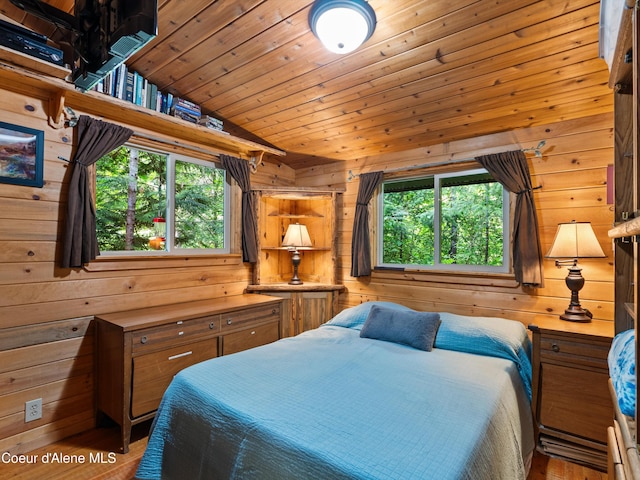 19565 N Goelzer Way, Rathdrum, ID 83858 - bedroom with wood walls, multiple windows, wood ceiling, wood finished floors, and vaulted ceiling