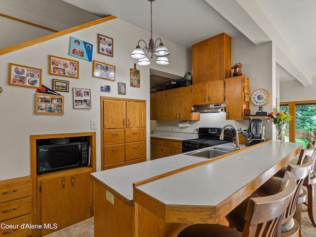 19565 N Goelzer Way, Rathdrum, ID 83858 - kitchen with black appliances, under cabinet range hood, light countertops, brown cabinets, and a peninsula