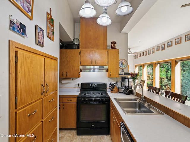 19565 N Goelzer Way, Rathdrum, ID 83858 - kitchen with black gas range, range hood, light countertops, and brown cabinetry