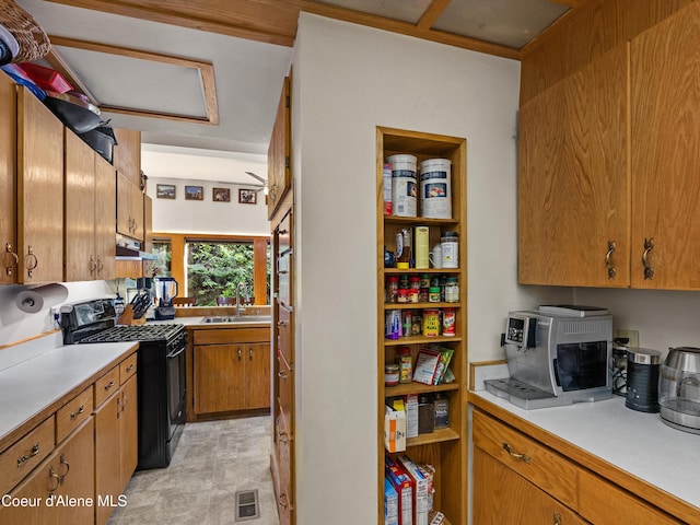 19565 N Goelzer Way, Rathdrum, ID 83858 - kitchen featuring gas stove, under cabinet range hood, light countertops, and brown cabinets