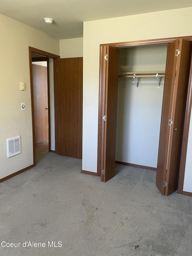 6953 N Caracara Ln, Coeur Dalene, ID 83815 - unfurnished bedroom with carpet, heating unit, and a closet