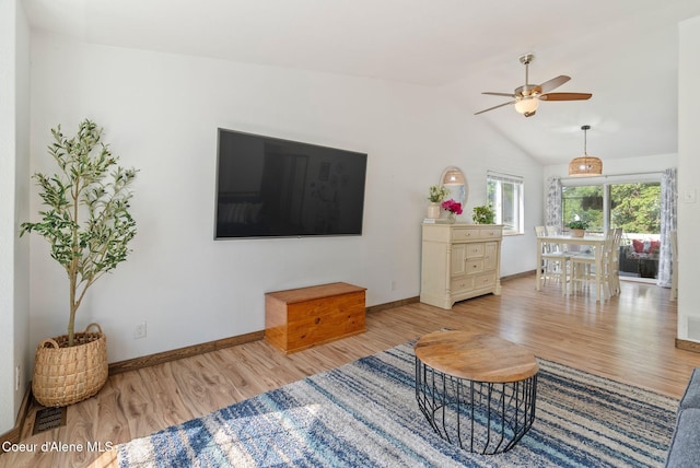 7560 W Sunrise St, Rathdrum, ID 83858 - living room with wood finished floors, a ceiling fan, and lofted ceiling