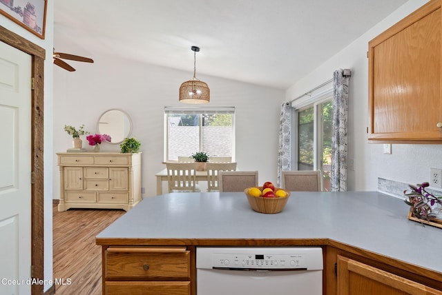 7560 W Sunrise St, Rathdrum, ID 83858 - kitchen with white dishwasher, vaulted ceiling, a peninsula, light wood-style flooring, and pendant lighting
