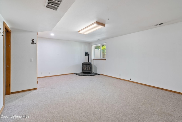 7560 W Sunrise St, Rathdrum, ID 83858 - basement with a wood stove, carpet, and recessed lighting
