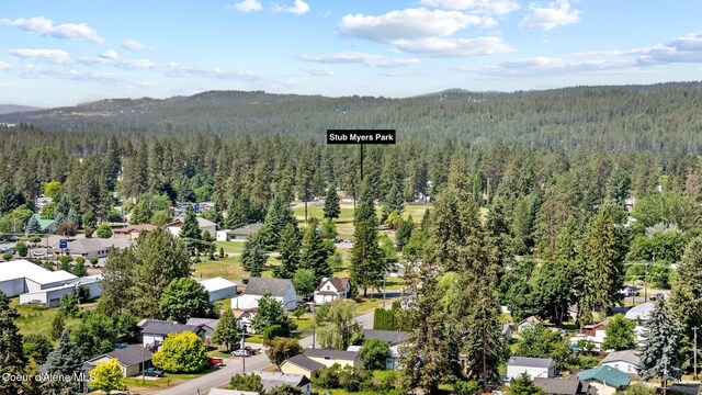 7560 W Sunrise St, Rathdrum, ID 83858 - aerial perspective of suburban area with a heavily wooded area and mountains