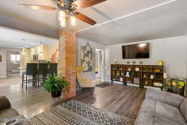 1318 N 10th St, Coeur Dalene, ID 83814 - living room featuring a ceiling fan, wood finished floors, and arched walkways