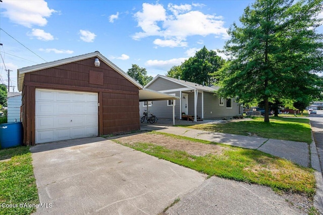 1318 N 10th St, Coeur Dalene, ID 83814 - view of front of home with concrete driveway, a detached garage, an outbuilding, and a front lawn