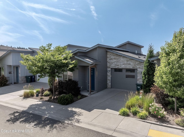 2999 N Casa Ct, Coeur Dalene, ID 83814 - view of front facade with stone siding, concrete driveway, and an attached garage