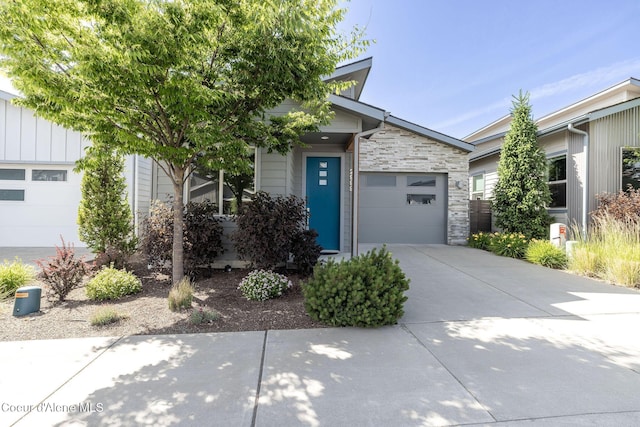2999 N Casa Ct, Coeur Dalene, ID 83814 - view of front of property with concrete driveway, stone siding, and a garage