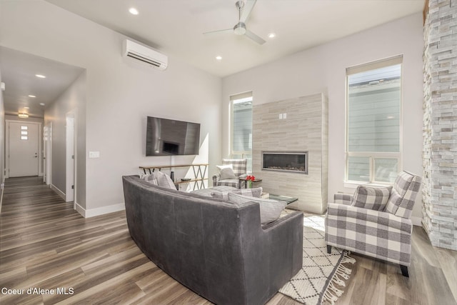 2999 N Casa Ct, Coeur Dalene, ID 83814 - living area with ceiling fan, an AC wall unit, wood finished floors, recessed lighting, and a tile fireplace