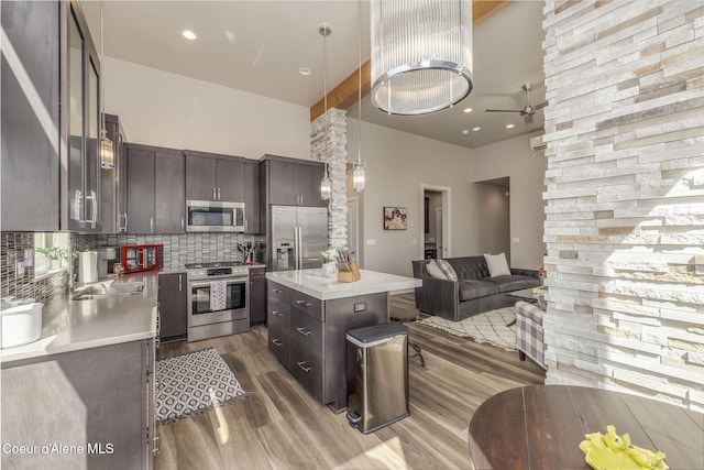 2999 N Casa Ct, Coeur Dalene, ID 83814 - kitchen with stainless steel appliances, wood finished floors, open floor plan, light countertops, and backsplash