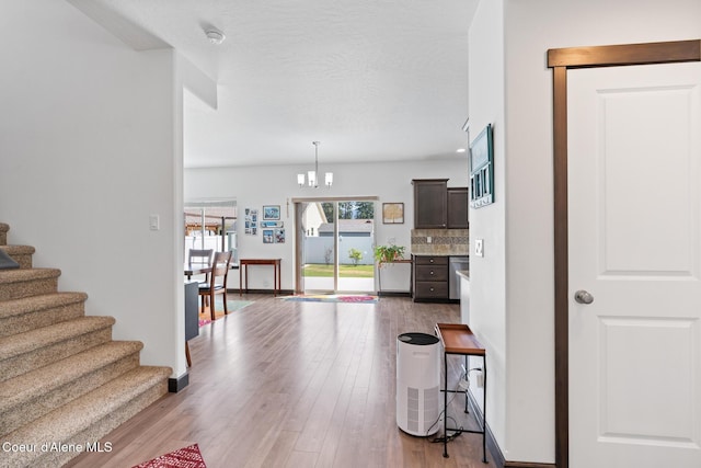 6522 N Idlewood Dr, Coeur Dalene, ID 83815 - living room featuring stairway, wood finished floors, and a chandelier