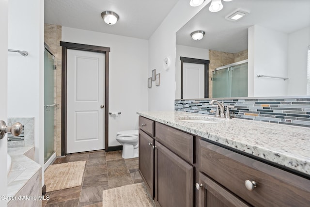 6522 N Idlewood Dr, Coeur Dalene, ID 83815 - full bathroom with vanity, a shower stall, decorative backsplash, and a bath