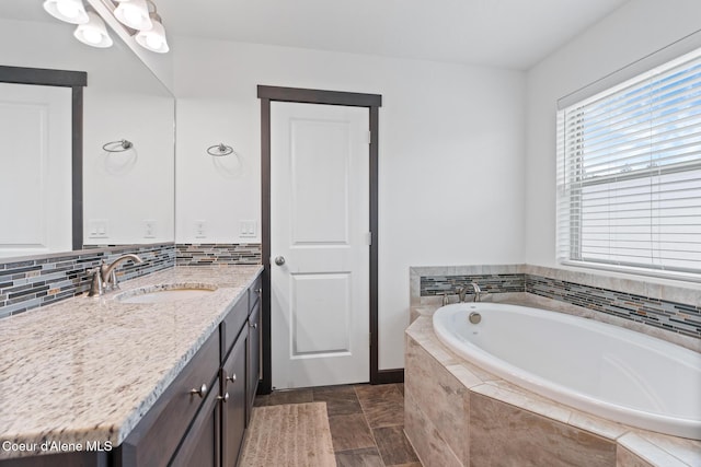6522 N Idlewood Dr, Coeur Dalene, ID 83815 - bathroom featuring vanity, a garden tub, and backsplash
