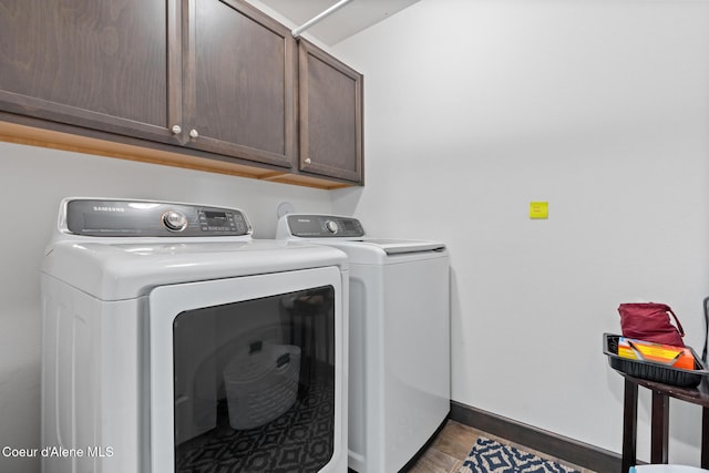 6522 N Idlewood Dr, Coeur Dalene, ID 83815 - washroom with cabinet space, washer and dryer, and wood finished floors