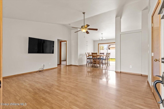 1601 N Summer Rose St, Post Falls, ID 83854 - living room with ceiling fan, light wood-style floors, vaulted ceiling, and a chandelier