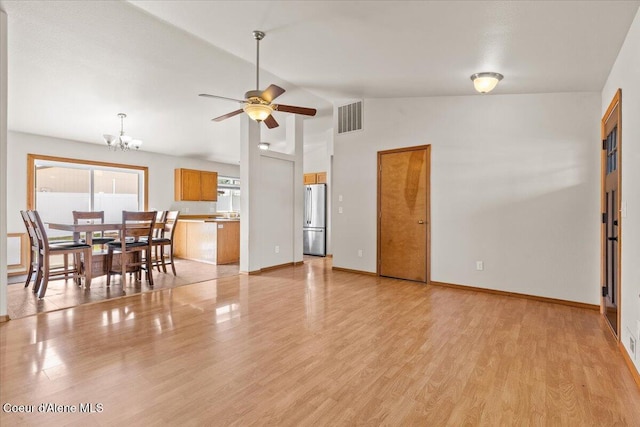 1601 N Summer Rose St, Post Falls, ID 83854 - dining area with a ceiling fan, vaulted ceiling, light wood-style flooring, and a chandelier