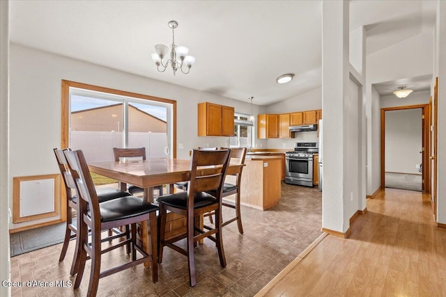 1601 N Summer Rose St, Post Falls, ID 83854 - dining area featuring a chandelier, vaulted ceiling, and light wood finished floors
