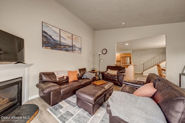 931 N Goldenrod Ct, Post Falls, ID 83854 - living area with wood finished floors, stairs, a fireplace, recessed lighting, and a textured ceiling