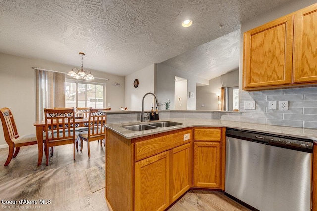 931 N Goldenrod Ct, Post Falls, ID 83854 - kitchen with dishwasher, light countertops, light wood finished floors, a textured ceiling, and vaulted ceiling
