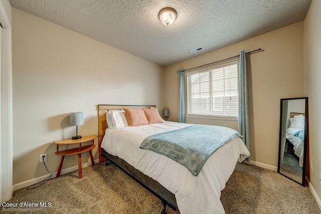 931 N Goldenrod Ct, Post Falls, ID 83854 - carpeted bedroom featuring baseboards and a textured ceiling
