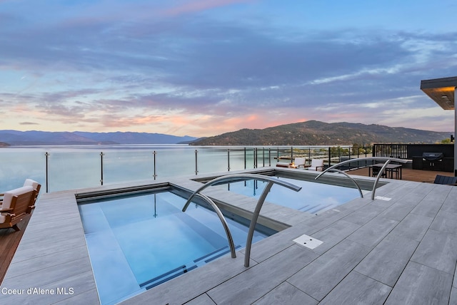 802 Sandpoint Ave # 8302, Sandpoint, ID 83864 - pool at dusk featuring a mountain view and an outdoor pool