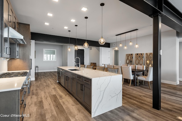 802 Sandpoint Ave # 8302, Sandpoint, ID 83864 - kitchen featuring under cabinet range hood, wood finished floors, a large island, and decorative light fixtures