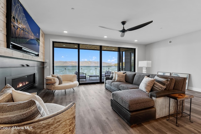 802 Sandpoint Ave # 8302, Sandpoint, ID 83864 - living room with wood finished floors, ceiling fan, a large fireplace, and recessed lighting