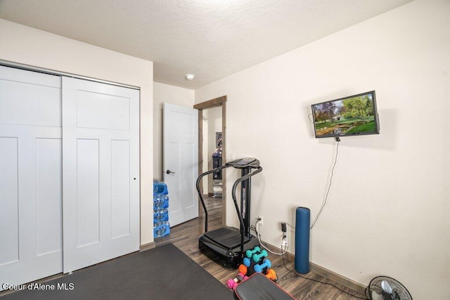 7934 W Kayak Ct, Rathdrum, ID 83858 - workout room featuring wood finished floors and a textured ceiling