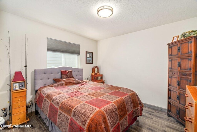 7934 W Kayak Ct, Rathdrum, ID 83858 - bedroom featuring dark wood-style flooring and a textured ceiling