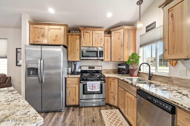 7934 W Kayak Ct, Rathdrum, ID 83858 - kitchen with stainless steel appliances, dark wood-type flooring, light stone counters, hanging light fixtures, and recessed lighting
