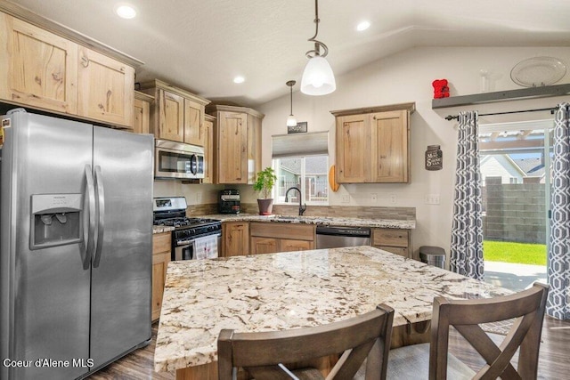 7934 W Kayak Ct, Rathdrum, ID 83858 - kitchen featuring appliances with stainless steel finishes, vaulted ceiling, dark wood-type flooring, light stone countertops, and recessed lighting