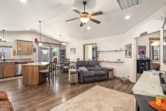 7934 W Kayak Ct, Rathdrum, ID 83858 - living area featuring vaulted ceiling, ceiling fan, dark wood finished floors, recessed lighting, and a textured ceiling
