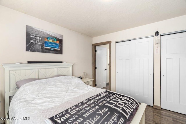 7934 W Kayak Ct, Rathdrum, ID 83858 - bedroom with dark wood-type flooring and a textured ceiling