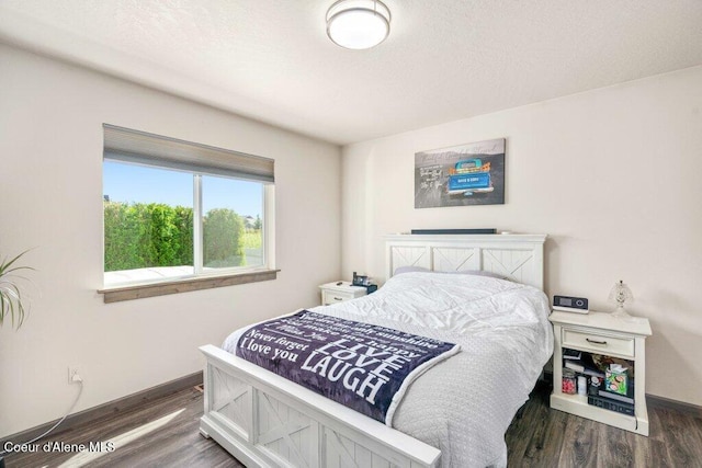 7934 W Kayak Ct, Rathdrum, ID 83858 - bedroom featuring wood finished floors and a textured ceiling