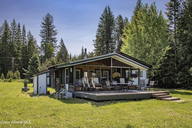 12 Otts Basin Rd, Sagle, ID 83860 - rear view of house with a lawn and a wooden deck
