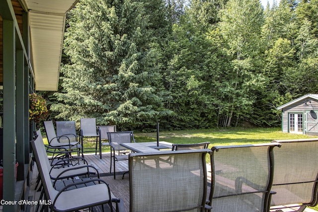 12 Otts Basin Rd, Sagle, ID 83860 - view of patio with outdoor dining space, a deck, and an outdoor structure