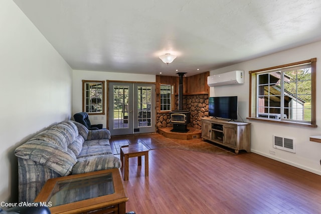 12 Otts Basin Rd, Sagle, ID 83860 - living room featuring a wall unit AC, french doors, healthy amount of natural light, and wood finished floors
