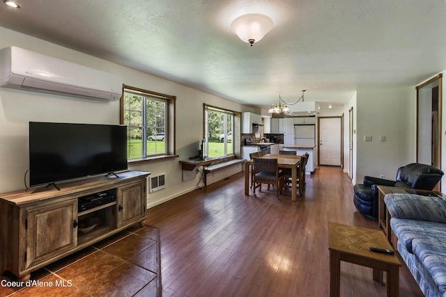 12 Otts Basin Rd, Sagle, ID 83860 - living area with an AC wall unit, a chandelier, and dark wood-style flooring