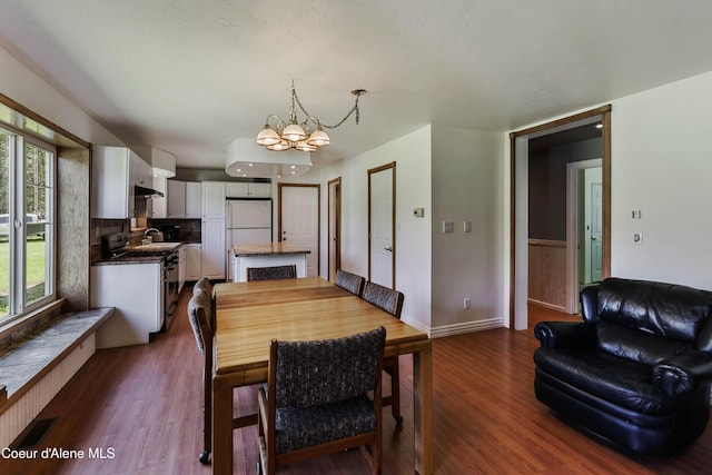 12 Otts Basin Rd, Sagle, ID 83860 - dining area with a chandelier and dark wood-style floors